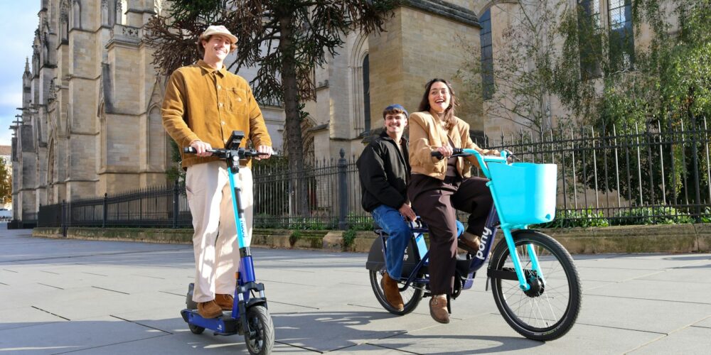 People riding electric scooter and bicycle outdoors